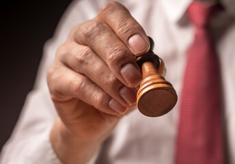 Man stepping with pawn piece. Concept of first step, starting, beginning in business
