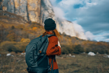 travel tourism woman with backpack high mountains sky landscape