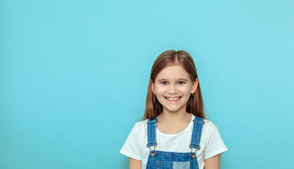 Cute portrait of a little girl. Funny child in a white T-shirt studio shot, isolated on a gray background. People, beauty, children's lifestyle concept