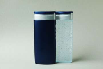Bottles of shower gel on light gray background