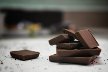 Broken chocolate bar left position isolated on white table. Horizontal composition. Top view