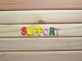Word Support on wood background