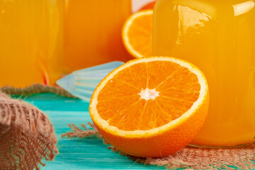 Glass with orange juice on green wooden table
