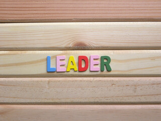 Word Leader on wood background