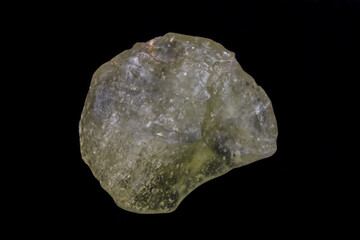 Yellow specimen of Libyan desert glass. Translucent to transparent, weighing 45.0 grams. Surface is smooth, mottled, with evidence of flowing motion. Photographed with black background.