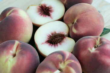Top view Fresh Peach with leaf closeup, Peach fruit on wooden table.