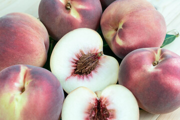 Top view Fresh Peach with leaf closeup, Peach fruit on wooden table.