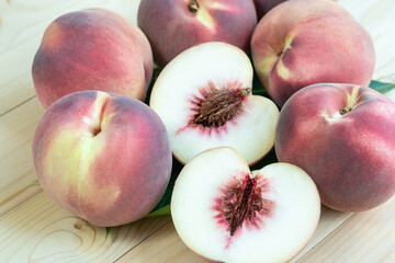Top view Fresh Peach with leaf closeup, Peach fruit on wooden table.