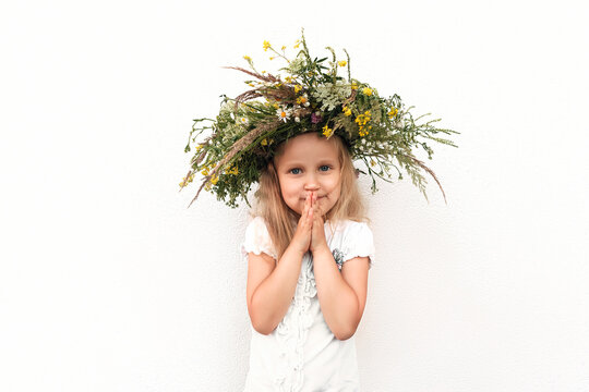 Flower Wreath from Wildflower on Kid Little girl. Little blonde girl in Wreath of wildflowers on white background