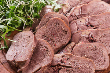 Boiled beef tongue, a delicacy. Slices of cold beef tongue.