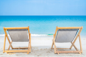 Beach chair on the sand beach sea side in frontwith clear blue sky. nobody background with copy space for text. Summer relax on travel vacation concept.