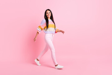 Full length profile side photo of young cheerful girl happy positive smile go walk step isolated over pastel color background