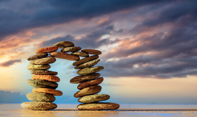 Zen stones bridge stack on blue sky and sea background.