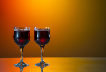 Two glasses of red wine on a beautiful sunset background. holiday mood