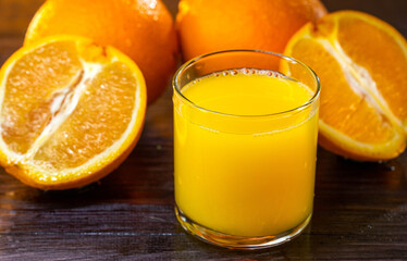 Oranges and juce shot on wooden base. Summer mood. Health