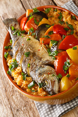 Thieboudienne Ceebu Jen Poisson au Riz a delicious one-pot meal with rice, fish stew and a variety of vegetables that is popular in Senegal closeup on the table. Vertical
