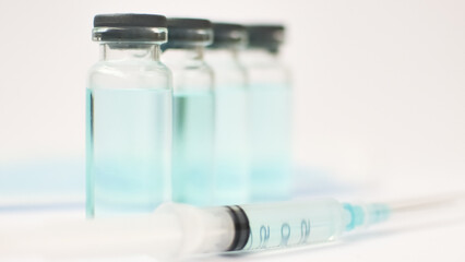 Medical ampoules and insulin syringe isolated on white background, vaccination concept