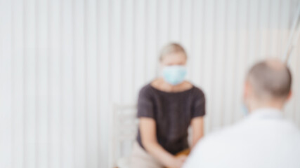 Obraz premium blurry image of a doctor consulting a mature woman .