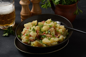Kartoffelsalat - traditional German potato salad. Potato salad with bacon
