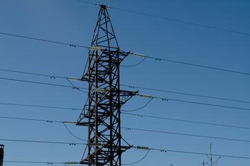 iron pillar with wires against the sky