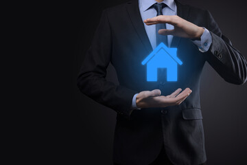 Real estate concept, businessman holding a house icon.House on Hand.Property insurance and security concept. Protecting gesture of man and symbol of house.