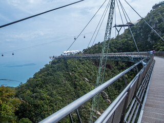"A close up on a Langkawi Sky Bridge located 660 metres above sea level at the peak of Gunung Mat Cincang on Pulau Langkawi. Bridge is bent in an arch, making it a nice walk across it, sky walking.."