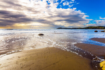 The sun's rays are reflected in the water