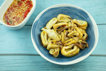 Squid grilled with charcoal on bowl.