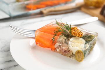Delicious aspic with meat and vegetables served on white marble table, closeup