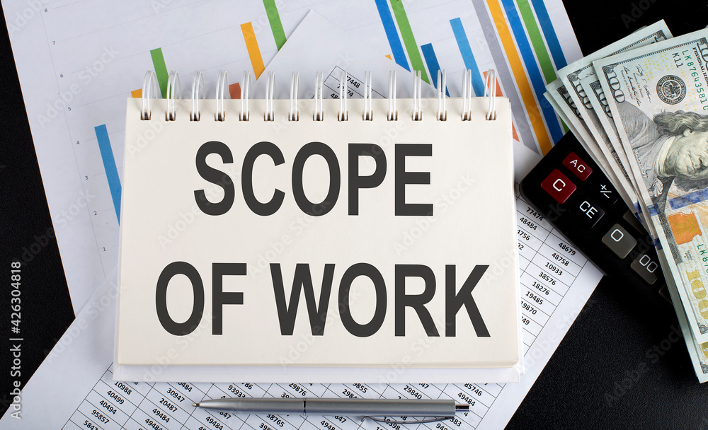 Poster scope of work text written on notebook with chart,calculator and dollars