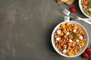 Delicious fresh chickpea salad served on grey table, flat lay. Space for text