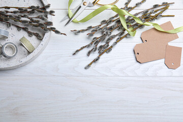 Beautiful pussy willow branches and wrapping materials on white wooden table, flat lay. Space for text © New Africa