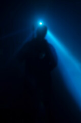 Defocused silhouette of a musician or singer on stage.