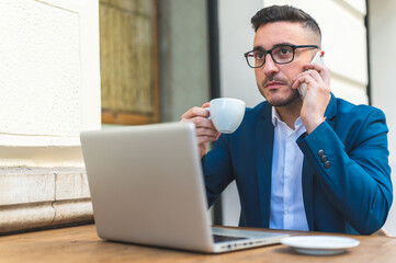 Businessman Having Phone Call in a Cafe Outdoors.