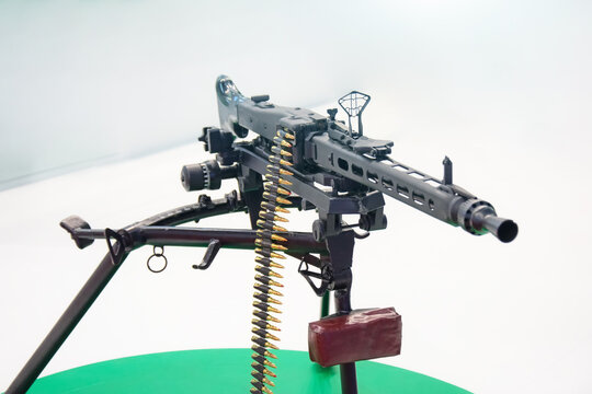 Black machine gun with chain of cartridges.