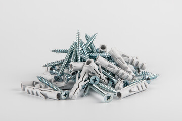 Screws with plastic dowels on a white background