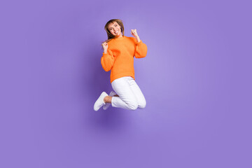 Fototapeta na wymiar Full length body size photo of jumping woman gesturing like winner carefree isolated pastel purple color background