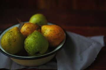Washed pears in a white cup on a towel. Pears from the garden. Pears in a plate. Pears on a towel.
