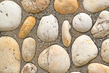 Fototapeta na wymiar sea pebbles in wall ornament , banner texture in abstract background