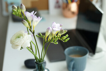 Bouquet of white ranunculus on the desk