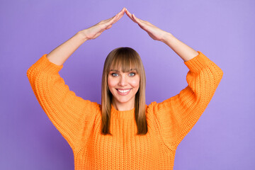 Photo of lady raise hands roof form shiny smile wear orange pullover isolated violet color...