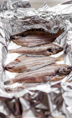 Raw flounder fish, seafood on baking foil. Healthy eating concept.