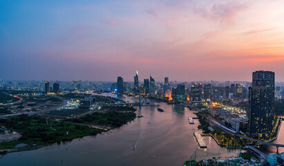 Aerial view of Ho Chi Minh city, Vietnam. Beauty skyscrapers along river light smooth down urban development. Dramatic lighting spectacular sunset.