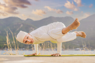 Kundalini yoga woman in white clothes and turban practices yoga kundalini on the background of the...