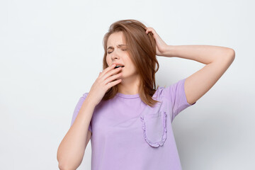 Fototapeta premium Portrait of tired girl, lacking sleep, feeling fatigue or boredom, yawn and cover yawning mouth
