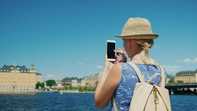 Woman tourist takes pictures of beautiful view in Stockholm