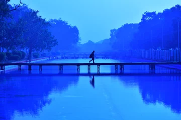 Acrylic prints Dark blue person on the lake