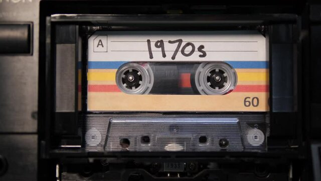 4K: Audio Cassette 1970s Tape playing in Recorder - Vintage Seventies or 70s retro music. Stock Video Clip Footage