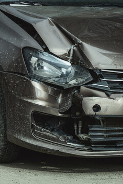 Crushed car front (face) after light auto traffic accident (crash). Vertical image.