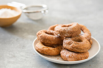 Homemade donuts sugar glazed on a stone background